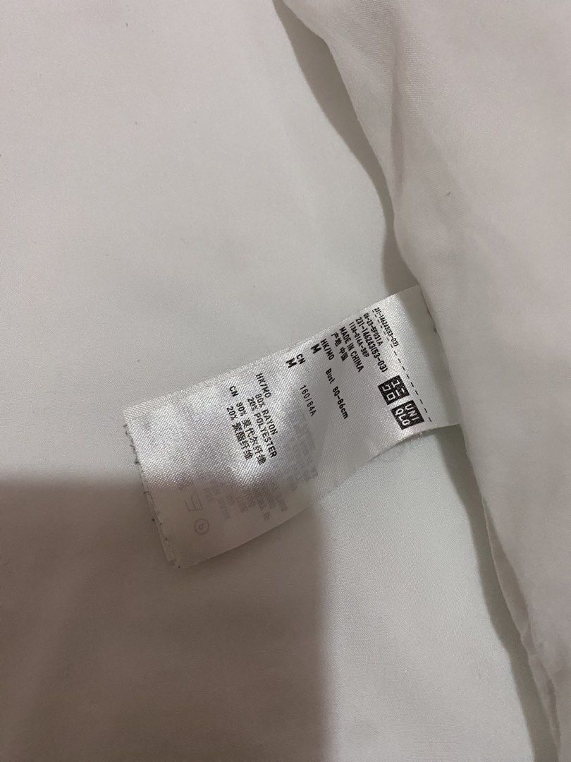 Uniqlo White Button-Up Shirt Size M (Category: Shirts) located in San Fernando. Submitted by celinaco (Listing ID 1443892498, Image 3). Description: Uniqlo White Button-Up Shirt (Size M). 80% Rayon, 20% Polyester. Classic, versatile style for casual or work. fits xs-s .