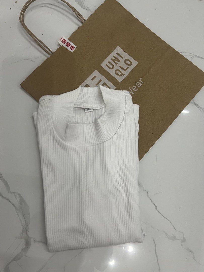 Uniqlo White Ribbed Mock Neck Top (Category: Shirts) located in Meycauayan. Submitted by twinblessing (Listing ID 1443874720, Image 1). Description: - White ribbed top from Uniqlo - Mock neck style - Made in Vietnam - Comfortable and versatile - Perfect for layering or wearing solo - Easily pairs with any outfit.