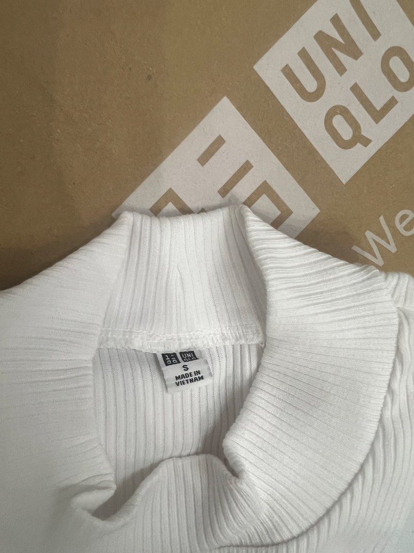 Uniqlo White Ribbed Mock Neck Top (Category: Shirts) located in Meycauayan. Submitted by twinblessing (Listing ID 1443874720, Image 2). Description: - White ribbed top from Uniqlo - Mock neck style - Made in Vietnam - Comfortable and versatile - Perfect for layering or wearing solo - Easily pairs with any outfit.