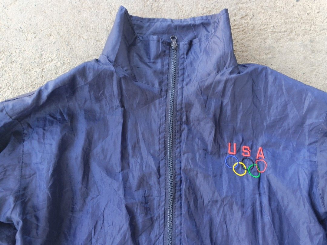 USA Olympic Track Jacket (Category: Coats, Jackets and Outerwear) located in Manila. Submitted by maverick_so.litt3 (Listing ID 1443736798, Image 2). Description: - Blue track jacket with USA Olympic rings logo - Full zip front closure - Stand-up collar design - Elasticated cuffs and hem for a snug fit - Ideal for casual wear or athletic activities.