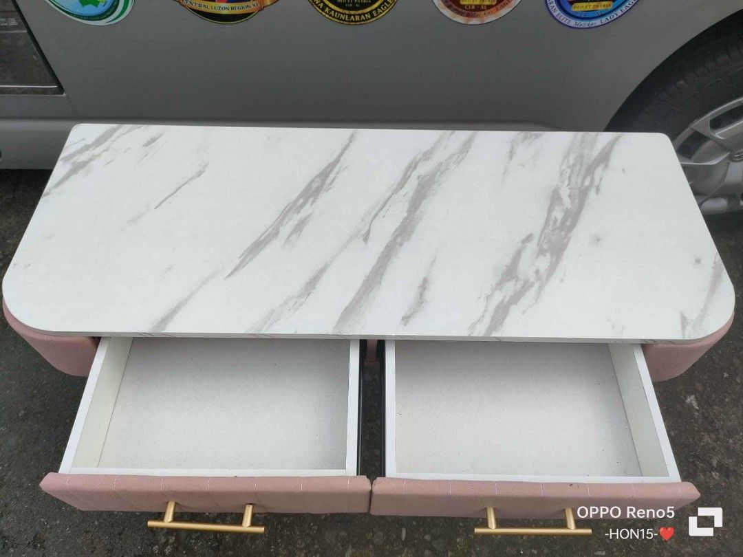 ✅velvet vanity table PINK 100x40x75cm (Category: Tables & Sets) located in Manila. Submitted by mightycloud_1992 (Listing ID 1443706124, Image 2). Description: - Adorable pink dressing table - Features a chic marble-effect top - Includes two convenient storage drawers - Stylish gold hairpin legs for a modern aesthetic - Ideal for bedrooms or vanity spaces - Approximately 80cm in length.