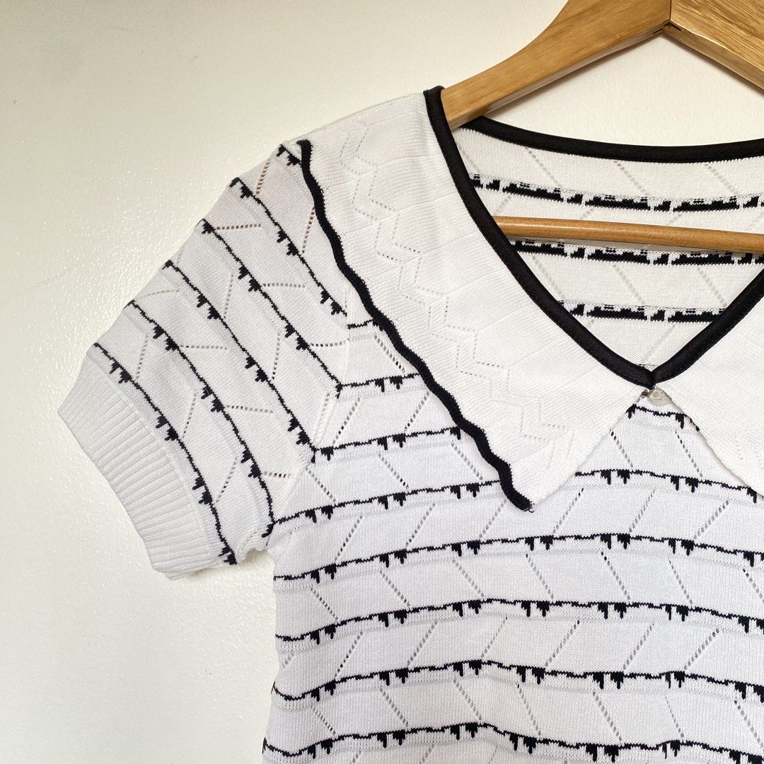 White Knit Top with Black Collar and Trim (Category: Blouses) located in Cavite. Submitted by branchee_chic (Listing ID 1443804941, Image 2). Description: - White short-sleeved knit top - Features a black geometric pattern - Adorable Peter Pan collar with black trim - Button detail at the collar - Trendy cropped length - Versatile for layering or wearing solo.