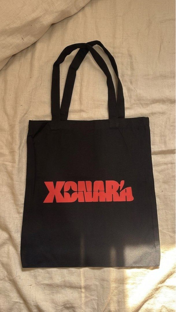 XONARA Giveaway Black Tote Bag (Category: Tote Bags) located in Quezon City. Submitted by amillionsuns (Listing ID 1443787838, Image 1). Description: - Durable black canvas tote bag - Features a bold red XONARA logo on the front - Simple and sturdy design with two shoulder straps - Ideal for everyday use, shopping, or carrying essentials - Easy to clean and built to last - Got from the Escolta event giveaway.