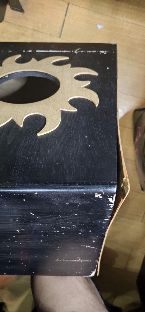 X-Pro Cajon Drum (Category: Musical Instruments) located in Pasig City. Submitted by JRisEn (Listing ID 1443879811, Image 2). Description: - X-Pro cajon drum - Black body with natural wood playing surface - Unique sun design cutout on the side - Shows some scuffs and wear on the black finish, particularly on top edges - Still a great instrument for percussion.