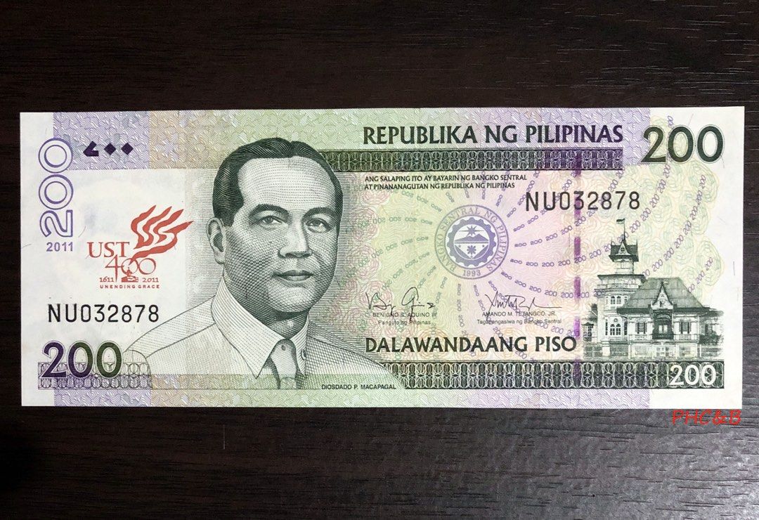 2011 200 Piso UST 400 Commemorative Banknote Overprint Banknote (Category: Currency) located in Valenzuela. Submitted by phcoins.banknotes08 (Listing ID 1443993790, Image 1). Description: 2011 200 Piso UST 400 Commemorative Banknote Overprint Banknote Uncirculated Grade - Authentic 200 Philippine Peso banknote - Features President Diosdado Macapagal on the front - Year 2011 clearly visible - Back displays a significant historical event - Ideal fo