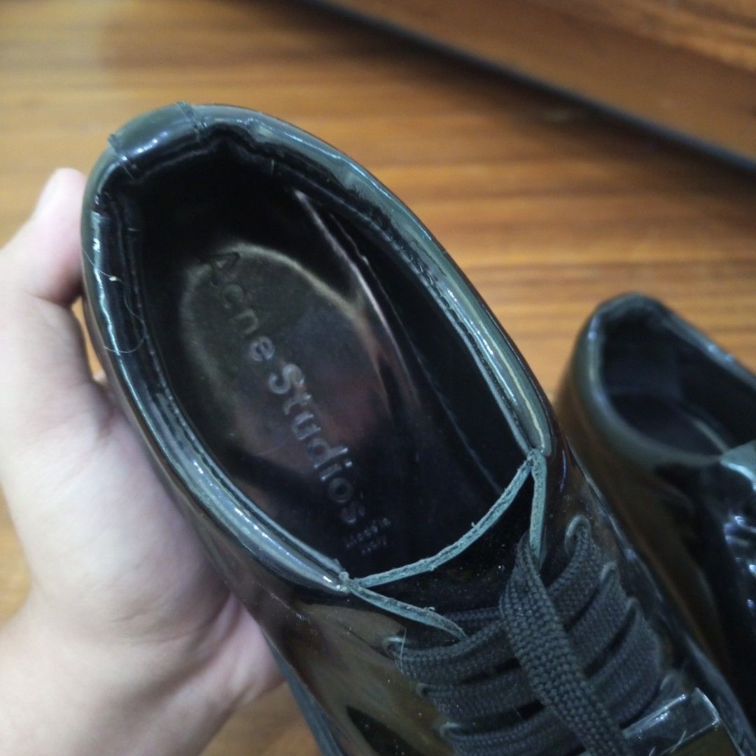 Acne Studios Black Patent Face Motif Sneakers (Category: Sneakers & Footwear) located in Calamba. Submitted by closet_from_the_past (Listing ID 1443938467, Image 3). Description: - Brand: Acne Studios -Size 6.6 - Material: Black patent leather - Feature: Signature face motif on front - Closure: Lace-up - Origin: Made in Italy - Style: Super shiny, eye-catching, statement piece.