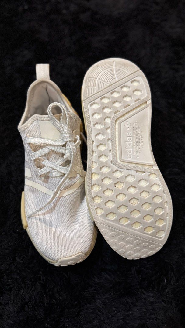 Adidas NMD R1 Triple White (Category: Sneakers) located in Quezon City. Submitted by lyhraaa (Listing ID 1444038300, Image 2). Description: Adidas NMD R1 Condition: 7/10 bcos of yellow stains Less than 5x ko lang to nasuot Huhuhu * Still structurally solid and comfortable * No major tears or sole separation * Some signs of use and storage * Midsole and plastic blocks have visible yellowing due to age/storage (see photos) * Upper remains in decent