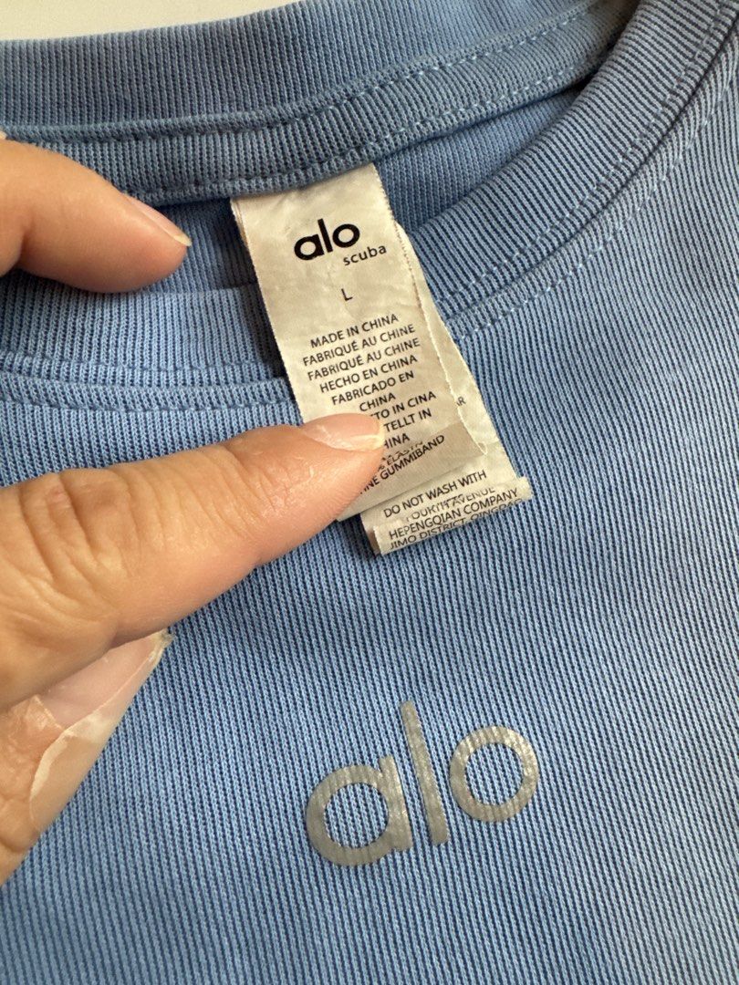 Alo Scuba Blue Ribbed Cropped T-Shirt Size L (Category: Shirts) located in Singapore. Submitted by greatworldand (Listing ID 1443925048, Image 2). Description: - Pretty blue Alo t-shirt - Ribbed material - Cropped style - Logo on front - Size L - Made in China - Care: Do not wash with like colors.