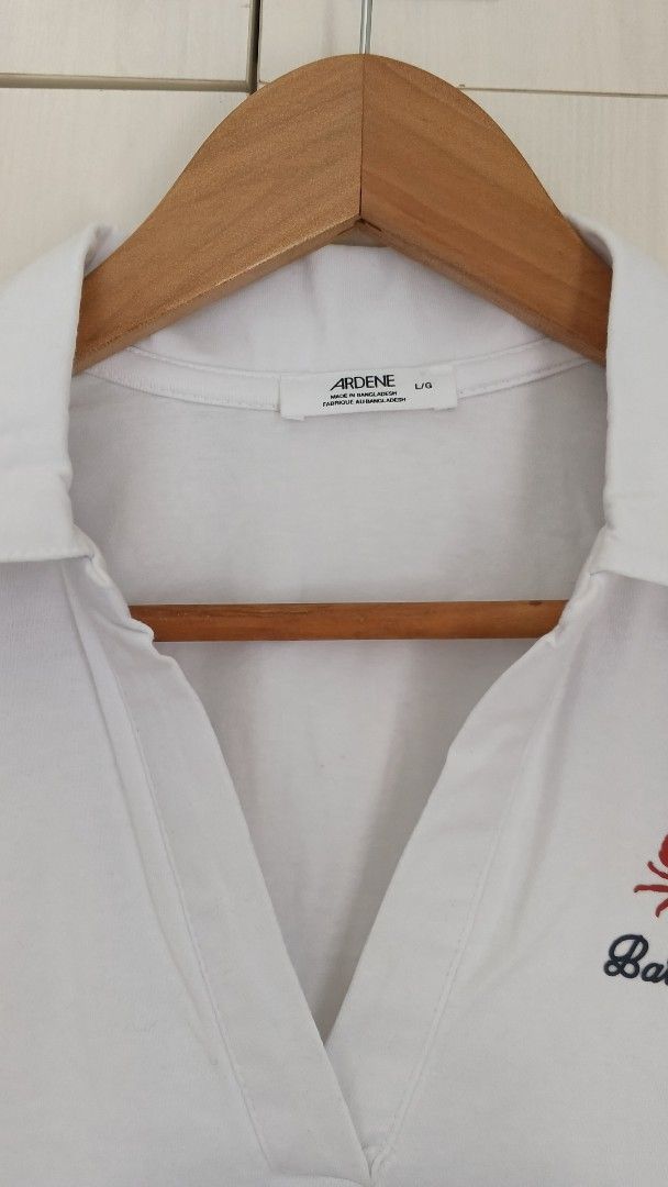 Ardene White Cropped Polo Shirt (Category: Blouses) located in Marikina City. Submitted by cheantone (Listing ID 1443972429, Image 2). Description: Bust | 19" Shoulder | 16" Length | 20".