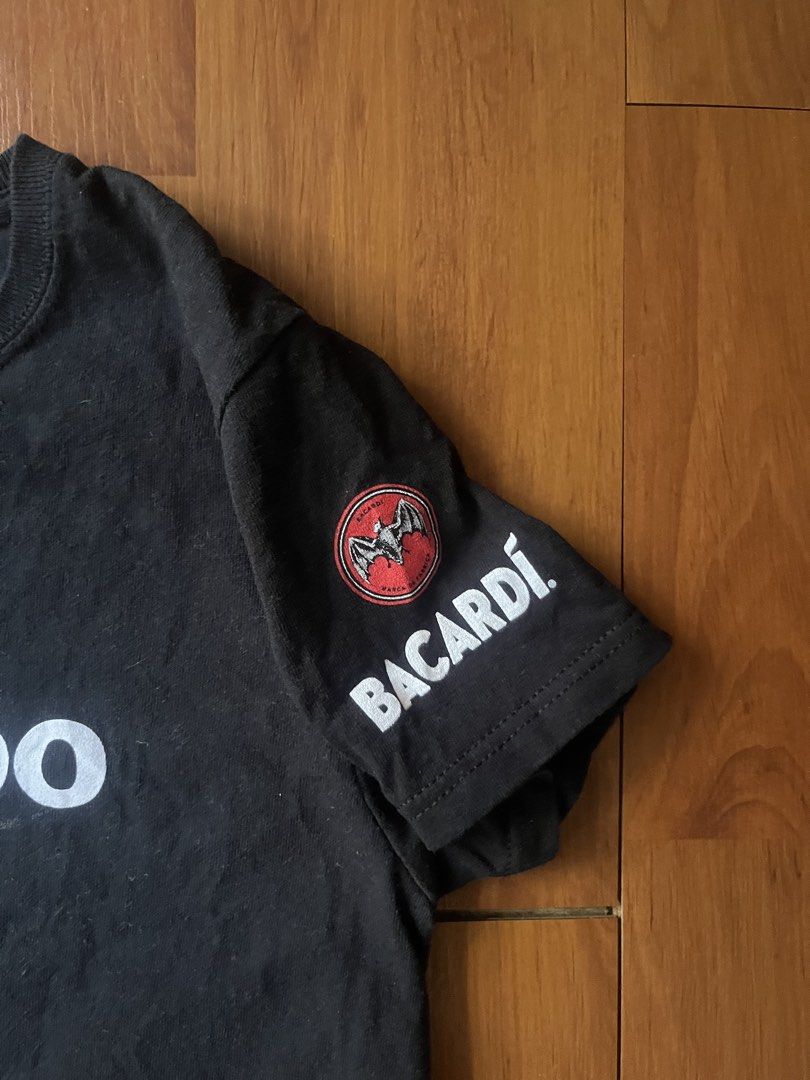 Bacardi Official Promo Graphic Tee Black - Small (Category: Shirts) located in Lipa City. Submitted by alexcollectionco (Listing ID 1444013365, Image 3). Description: Official Bacardi promo graphic t-shirt in black. Features text on both sides and the iconic Bacardi bat logo on the sleeve. Great piece for casual wear or anyone who collects alcohol promo merch. Key Features Brand: Bacardi Official Design: “Hey Boo” printed on the front, “Bye Boo” 