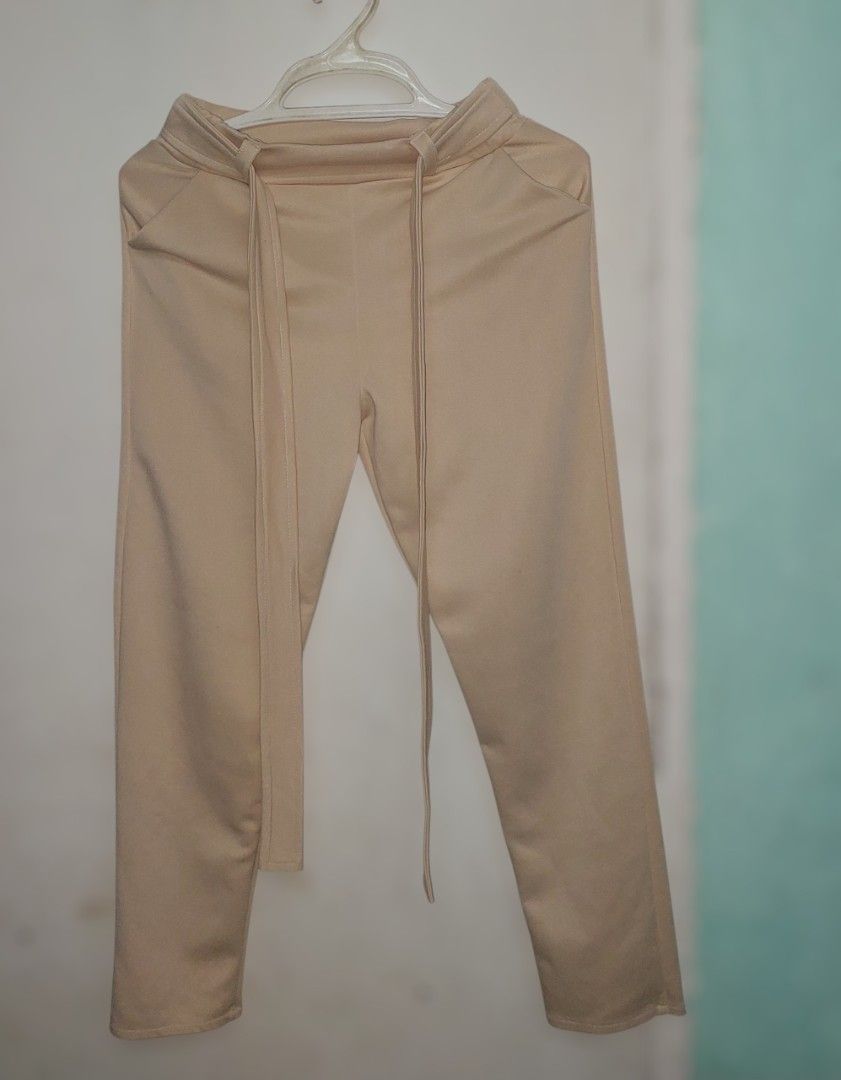 Beige and Brown Satin Pants with Belt (Category: Other Bottoms) located in General Trias. Submitted by isaki_21 (Listing ID 1443969739, Image 1). Description: Buy 2 for 200 Condition: Likely used Size: Can fit to 24 - 28 waistline.