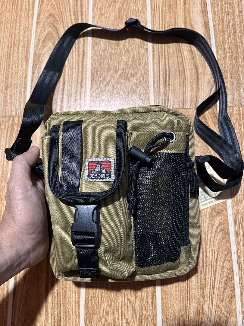 Ben Davis Crossbody Bag Khaki (Category: Sling Bags) located in Manila. Submitted by mjaothrift (Listing ID 1444066227, Image 2). Description: - Ben Davis crossbody bag - Color: Khaki - Front buckle pocket - Mesh side pocket - Adjustable strap - Ideal for everyday use - Comes with original tags.