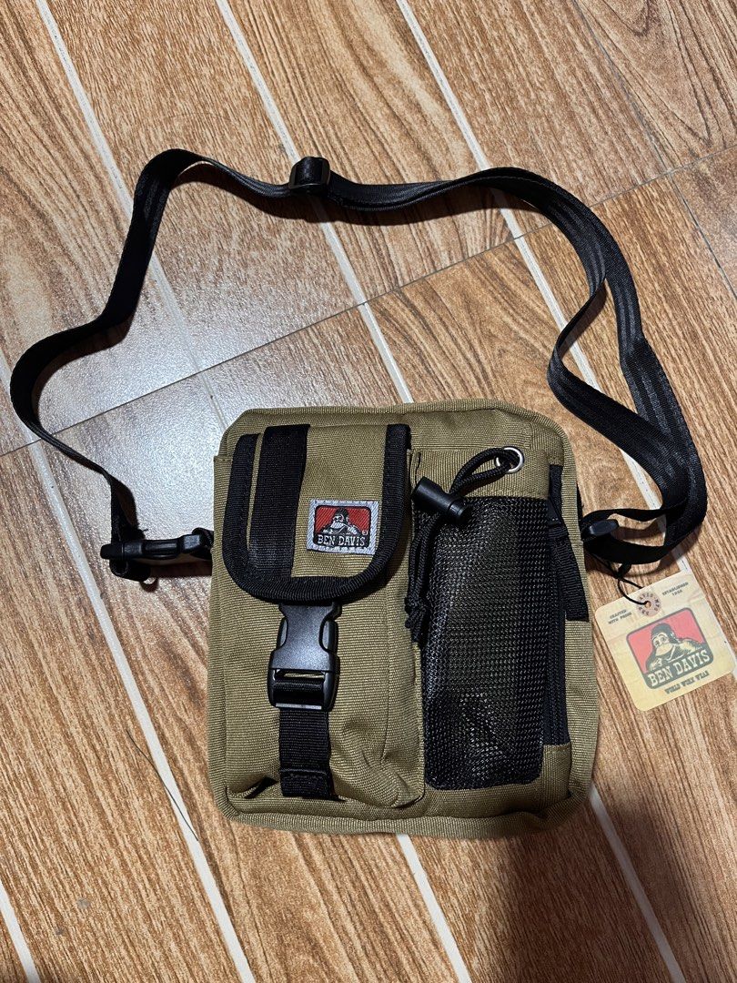 Ben Davis Crossbody Bag Khaki (Category: Sling Bags) located in Manila. Submitted by mjaothrift (Listing ID 1444066227, Image 1). Description: - Ben Davis crossbody bag - Color: Khaki - Front buckle pocket - Mesh side pocket - Adjustable strap - Ideal for everyday use - Comes with original tags.