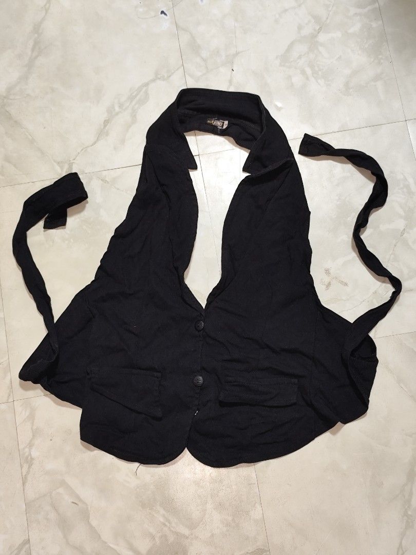 Black Halter Top Vest with Button Detail (Category: Sleeveless) located in Manila. Submitted by allaincecb (Listing ID 1443986223, Image 1). Description: - Black halter top with vest-like design - Features a collar and button closure down the front - Ties at the back for an adjustable fit - Made from a soft, flowy fabric - Versatile for layering or wearing solo.