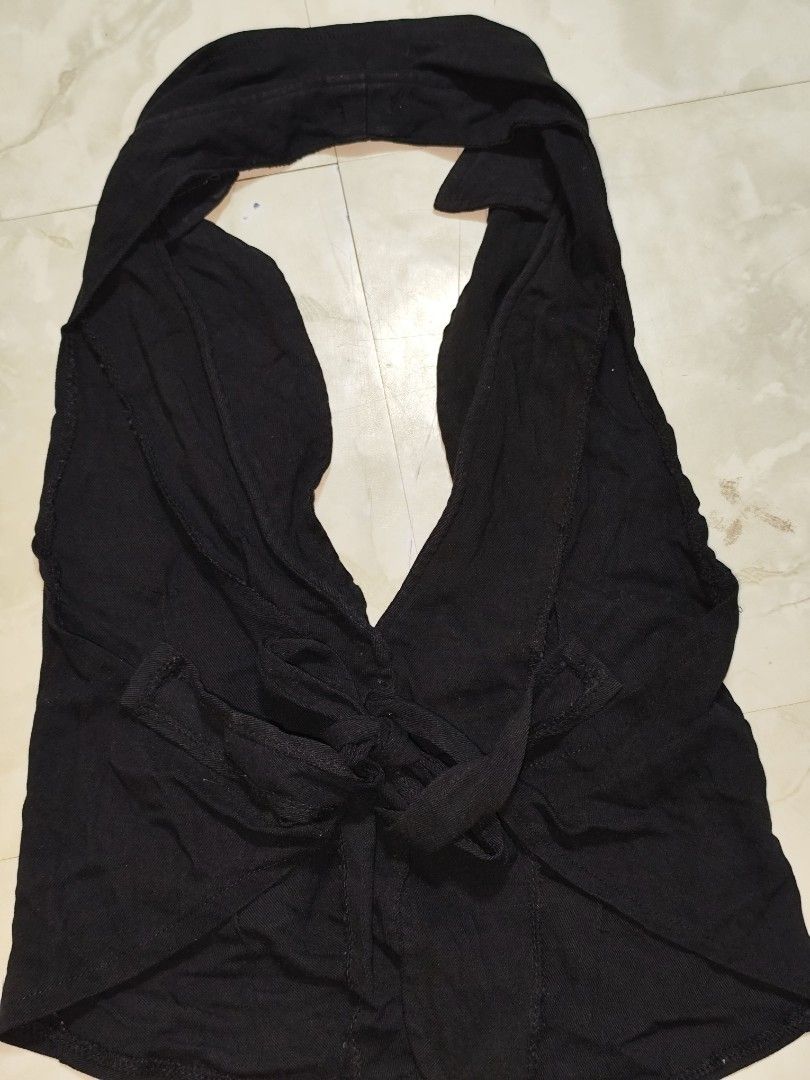 Black Halter Top Vest with Button Detail (Category: Sleeveless) located in Manila. Submitted by allaincecb (Listing ID 1443986223, Image 2). Description: - Black halter top with vest-like design - Features a collar and button closure down the front - Ties at the back for an adjustable fit - Made from a soft, flowy fabric - Versatile for layering or wearing solo.