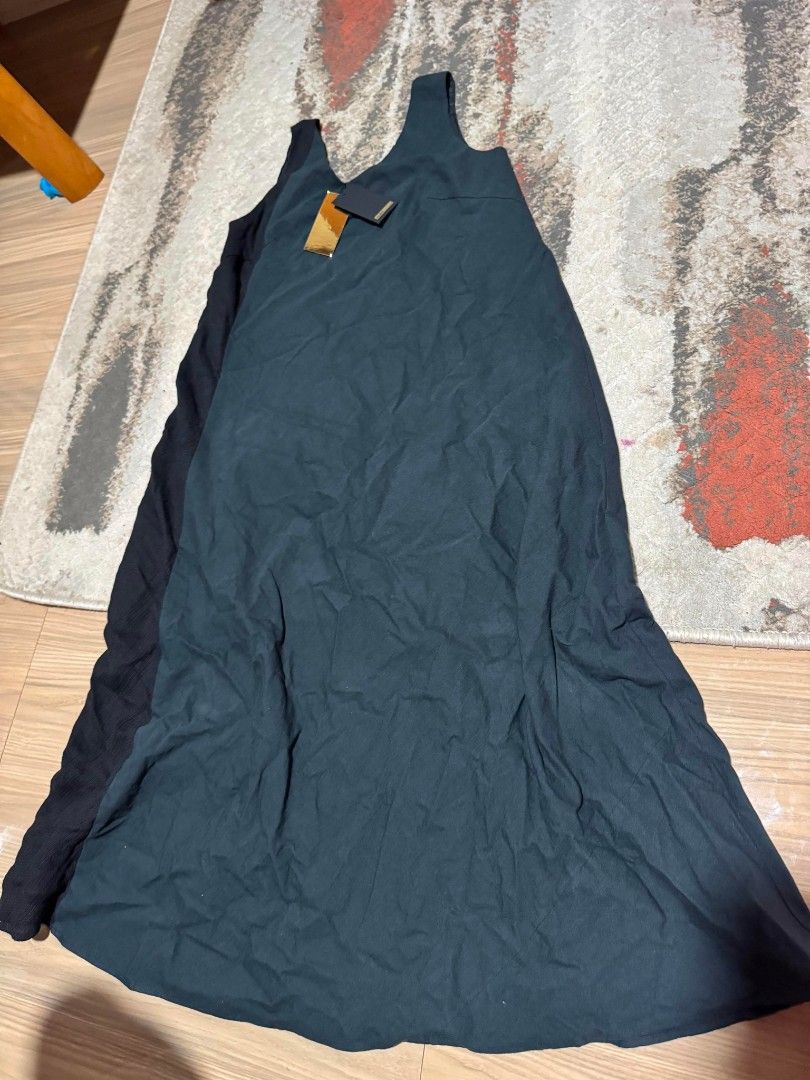 Black Maxi Dress with Tags (Category: Dresses) located in Valencia. Submitted by declutterainnn (Listing ID 1443952358, Image 3). Description: - Brand new long black maxi dress - Sleeveless design - Flowy material - Perfect for casual wear or dressing up - Versatile and simple piece - Tags still attached.