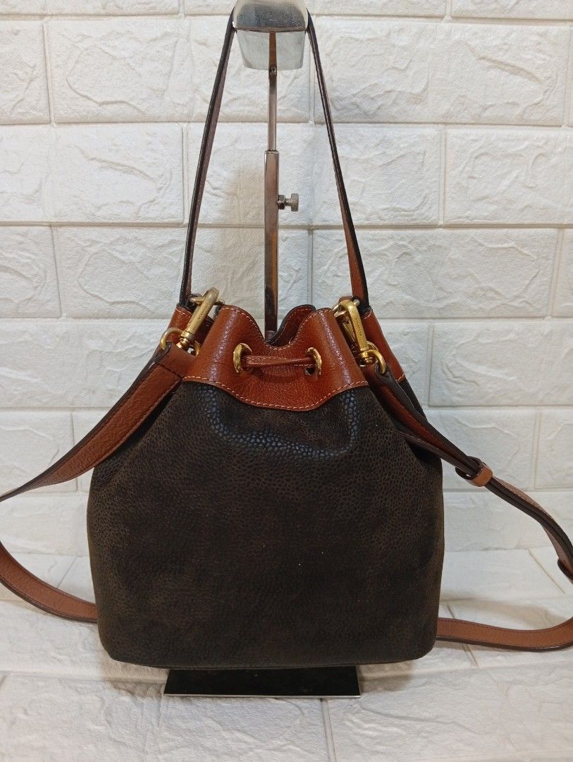 BRIC'S Brown Leather Bucket Bag (Category: Cross-body Bags) located in Las Pinas. Submitted by etoksi1234 (Listing ID 1443996177, Image 2). Description: Pre-loved Classic BRIC'S dark brown pebbled leather bucket bag with tan trim. Drawstring closure, adjustable strap, gold hardware. Looks new, replaced sling only..