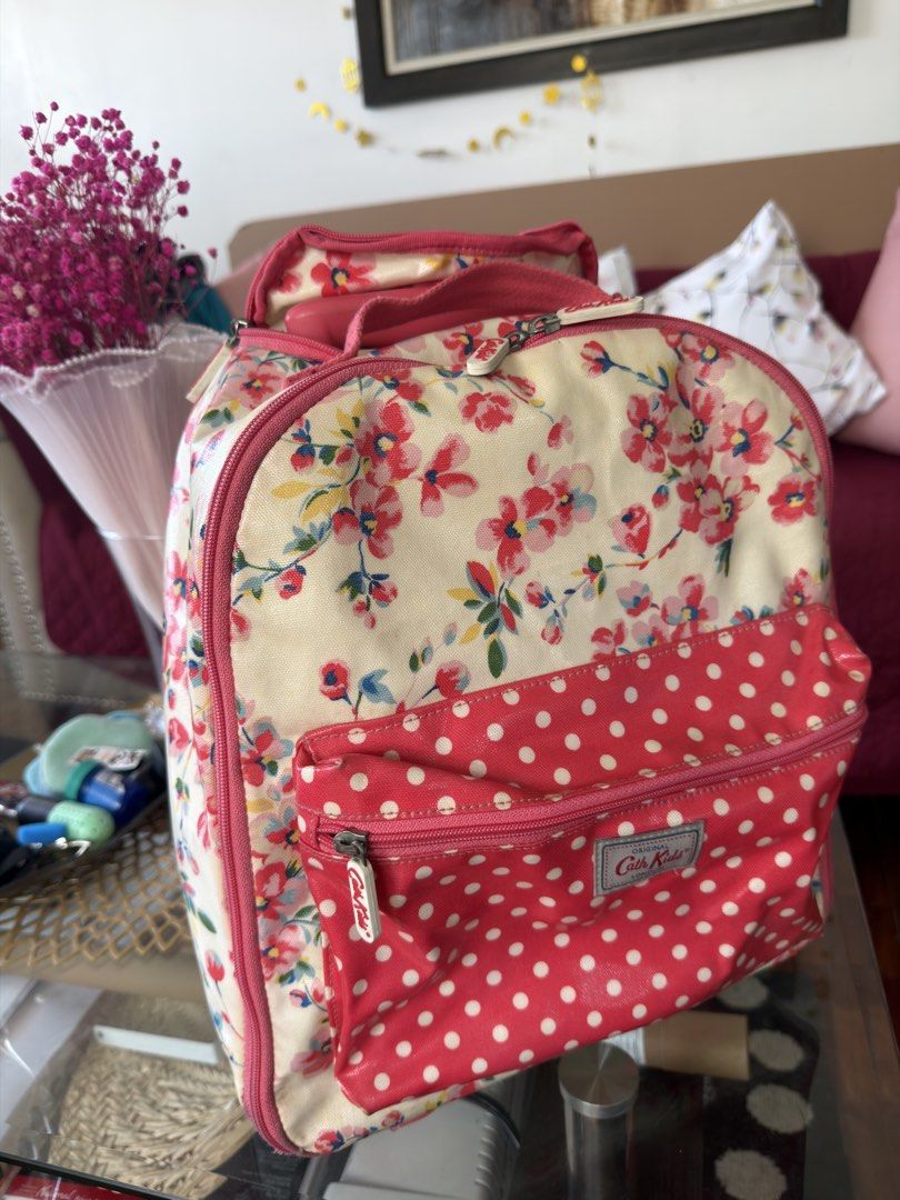 Cath Kidston Kids Floral Polka Dot Rolling Backpack (Category: Backpacks) located in Manila. Submitted by ameerafaye (Listing ID 1443922430, Image 2). Description: - Adorable Cath Kidston backpack for kids - Charming floral print on cream with pink polka dot pockets - Features a retractable handle and wheels for easy rolling - Spacious interior for school supplies or travel essentials - Zippers are in good working condition - Ideal for little adv