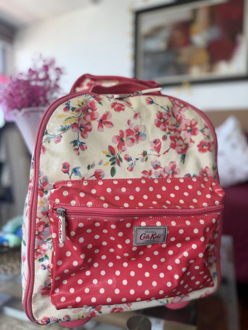 Cath Kidston Kids Floral Polka Dot Rolling Backpack (Category: Backpacks) located in Manila. Submitted by ameerafaye (Listing ID 1443922430, Image 3). Description: - Adorable Cath Kidston backpack for kids - Charming floral print on cream with pink polka dot pockets - Features a retractable handle and wheels for easy rolling - Spacious interior for school supplies or travel essentials - Zippers are in good working condition - Ideal for little adv
