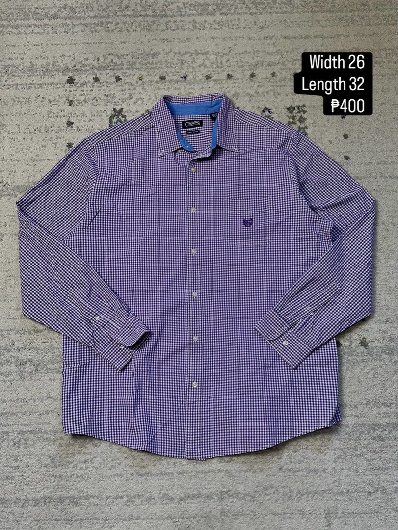 Chaps Purple Gingham Long Sleeve Button Down Shirt Men's Size (Category: Tshirts & Polo Shirts ) located in Daet. Submitted by thrifthings2018 (Listing ID 1443988955, Image 1). Description: - Chaps button down shirt - Classic purple and white gingham pattern - Long sleeves with button cuffs - Easy care fabric for convenience - Subtle chest logo detail - Measurements: Width 26 inches, Length 32 inches - Versatile for casual or smart casual occasio