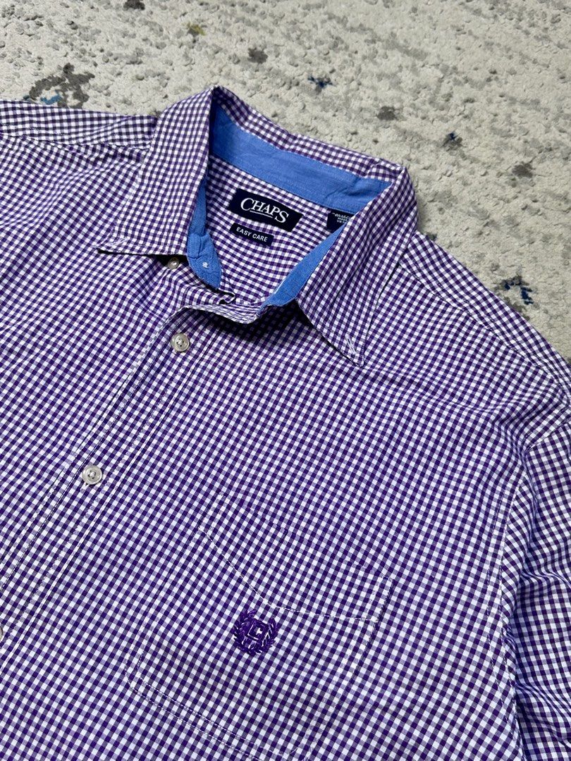 Chaps Purple Gingham Long Sleeve Button Down Shirt Men's Size (Category: Tshirts & Polo Shirts ) located in Daet. Submitted by thrifthings2018 (Listing ID 1443988955, Image 2). Description: - Chaps button down shirt - Classic purple and white gingham pattern - Long sleeves with button cuffs - Easy care fabric for convenience - Subtle chest logo detail - Measurements: Width 26 inches, Length 32 inches - Versatile for casual or smart casual occasio