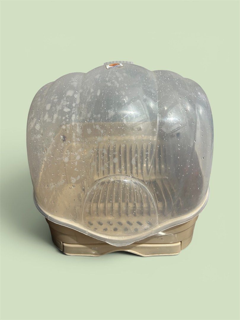 Clear Plastic Dish Rack with Lid (Category: Food Organization & Storage) located in Quezon City. Submitted by ambercabia26 (Listing ID 1444088303, Image 1). Description: - Clear plastic dish rack with a protective lid - Features multiple slots for organizing plates and cups - Neutral beige colored base - Note: Lid has some visible water spots - Ideal for efficient dish drying.