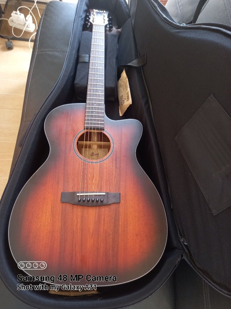 All-solid Cort Core Blackwood Acoustic-Electric Guitar (Category: Musical Instruments) located in Binan City. Submitted by graziosomoderato (Listing ID 1412372238, Image 1). Description: Cort Core all-solid blackwood OM Bone saddle and nut Like new, no signs of use, no scratches Setup: Low action Fretboard color: from original black to natural wood color Done at Elegee custom guitars Used at home only, sparingly, female owner. No issues Warm, bal
