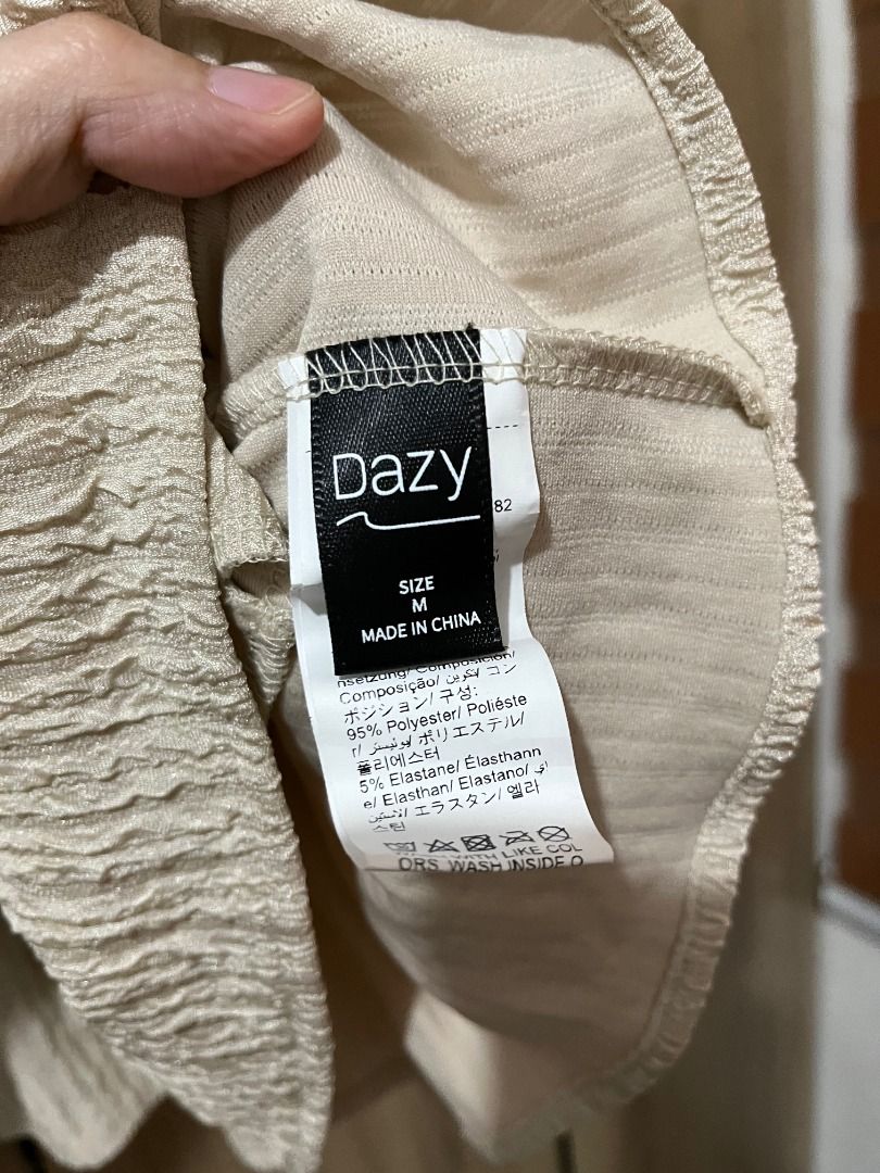 Dazy Layered Top Size (Category: Blouses) located in Cabanatuan. Submitted by declutteringhaven (Listing ID 1443931198, Image 2). Description: - Cream colored top from Dazy - Size: Medium (M) - Material: Polyester and elastane blend - Features: Textured fabric for a nice feel - Fit: Comfortable and stretchy - Occasion: Perfect for casual wear.