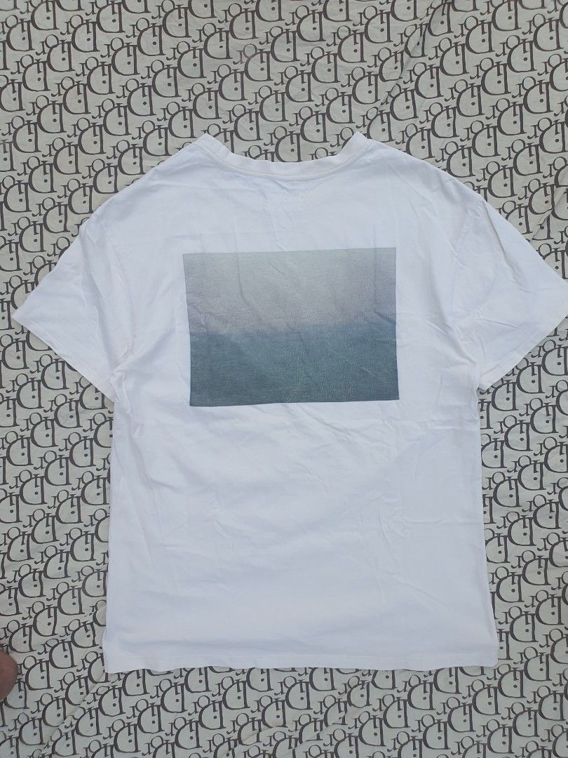 Fear of God Essentials White T-Shirt (Category: Tshirts & Polo Shirts ) located in San Fernando. Submitted by retro.district. (Listing ID 1444030687, Image 2). Description: - Brand: Fear of God Essentials - Color: White - Design: Features the iconic brand logo on the chest. - Back Detail: Includes a cool graphic print on the back. - Style: Comfortable and stylish, ideal for everyday casual wear. - Condition: Please check photos for detailed condi