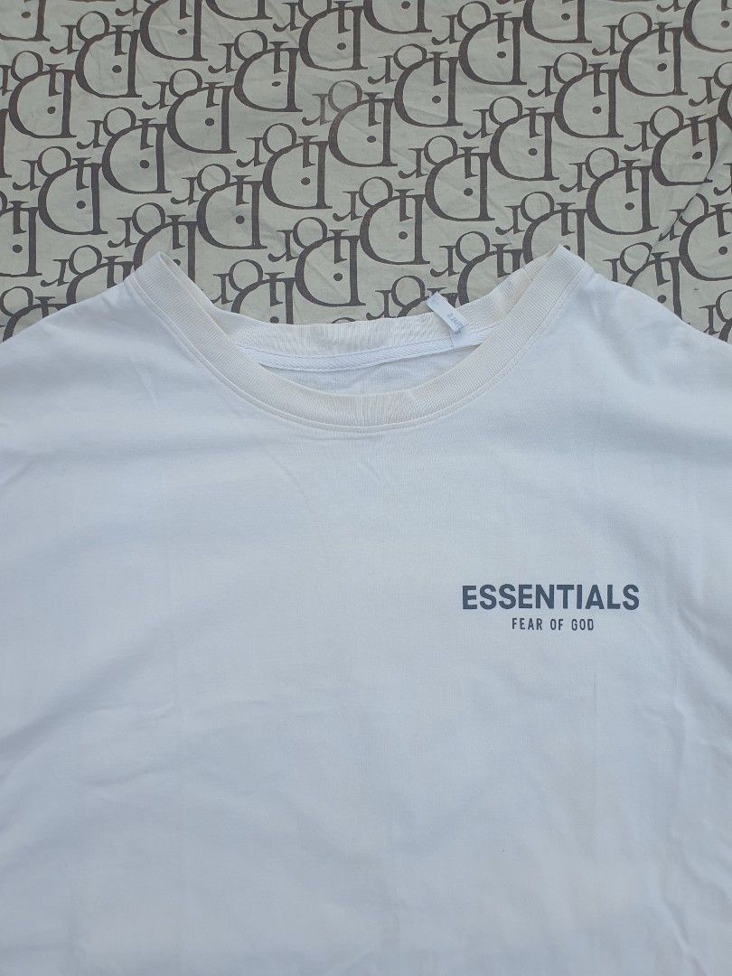 Fear of God Essentials White T-Shirt (Category: Tshirts & Polo Shirts ) located in San Fernando. Submitted by retro.district. (Listing ID 1444030687, Image 3). Description: - Brand: Fear of God Essentials - Color: White - Design: Features the iconic brand logo on the chest. - Back Detail: Includes a cool graphic print on the back. - Style: Comfortable and stylish, ideal for everyday casual wear. - Condition: Please check photos for detailed condi