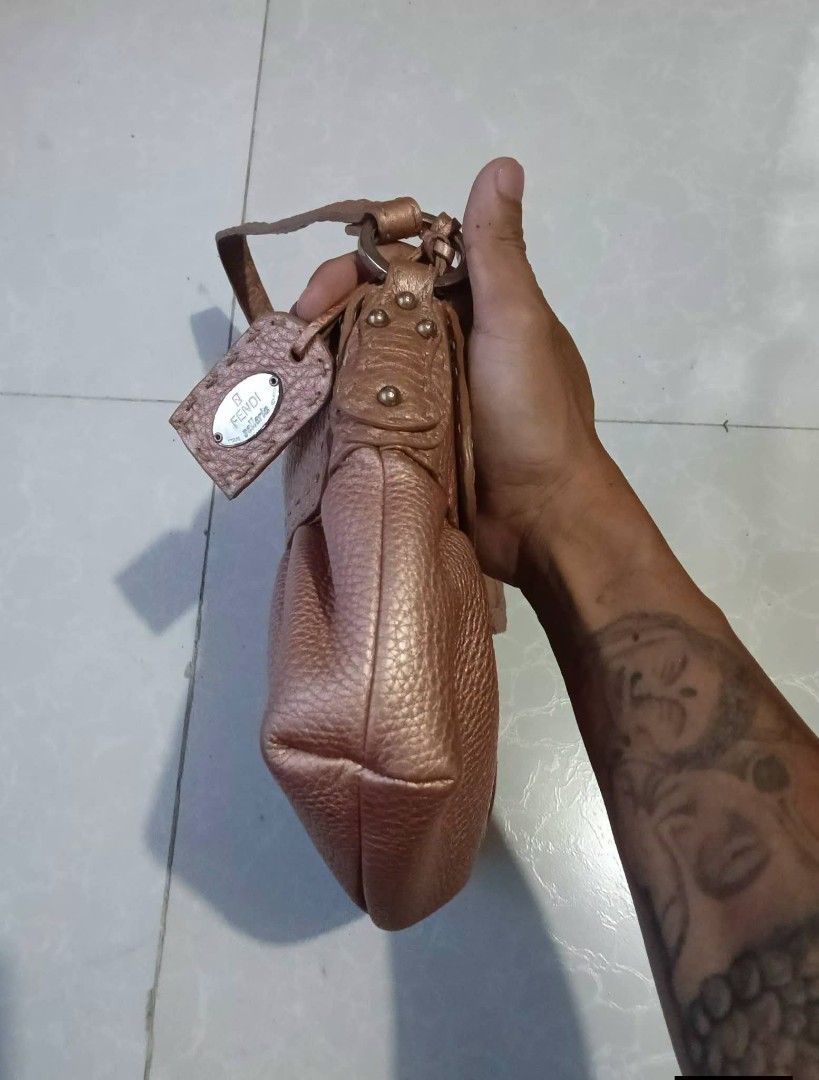 Fendi Spy Bag Rose Gold Leather (Category: Luxury Bags & Wallets) located in Manila. Submitted by braveturtle-540a03 (Listing ID 1443920752, Image 2). Description: - Authentic Fendi Spy Bag - Color: Rose Gold - Material: Pebbled Leather - Design: Gathered detail on the front - Closure: Magnetic snap - Interior: 1 zip pocket, 1 slip pocket - Authenticity: Comes with authenticity card - Includes: Original dust bag - Condition: Shows some signs of w