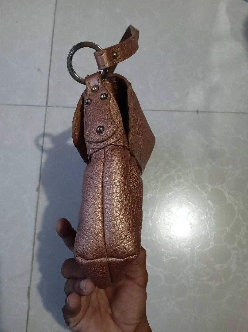 Fendi Spy Bag Rose Gold Leather (Category: Luxury Bags & Wallets) located in Manila. Submitted by braveturtle-540a03 (Listing ID 1443920752, Image 3). Description: - Authentic Fendi Spy Bag - Color: Rose Gold - Material: Pebbled Leather - Design: Gathered detail on the front - Closure: Magnetic snap - Interior: 1 zip pocket, 1 slip pocket - Authenticity: Comes with authenticity card - Includes: Original dust bag - Condition: Shows some signs of w