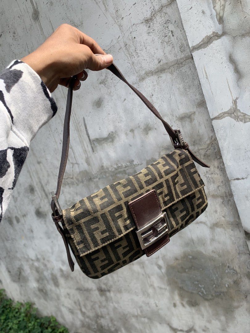 Fendi Zucca Baguette Bag (Category: Luxury Bags & Wallets) located in Polomolok. Submitted by domingthriftclothes (Listing ID 1443981863, Image 1). Description: - Classic Fendi Zucca baguette bag - Monogram canvas with leather trim - Silver hardware - Zipper closure inside - Made in Italy - Timeless piece, great for everyday use.
