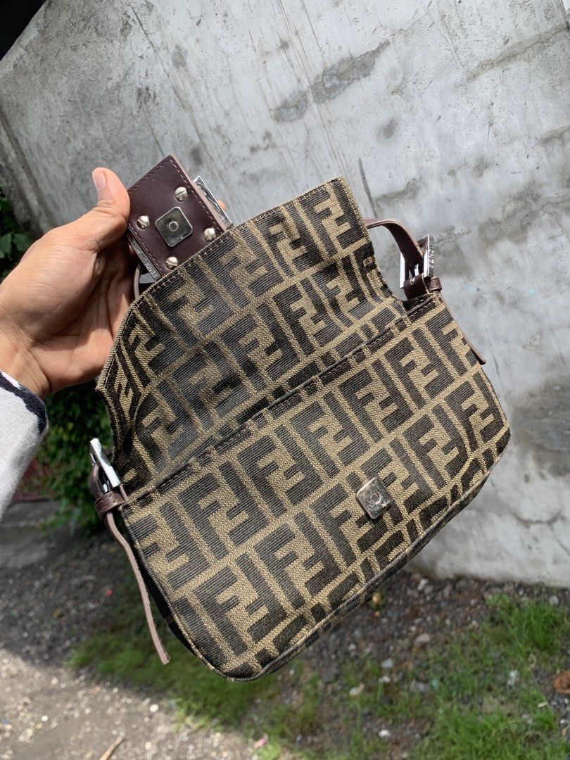 Fendi Zucca Baguette Bag (Category: Luxury Bags & Wallets) located in Polomolok. Submitted by domingthriftclothes (Listing ID 1443981863, Image 3). Description: - Classic Fendi Zucca baguette bag - Monogram canvas with leather trim - Silver hardware - Zipper closure inside - Made in Italy - Timeless piece, great for everyday use.