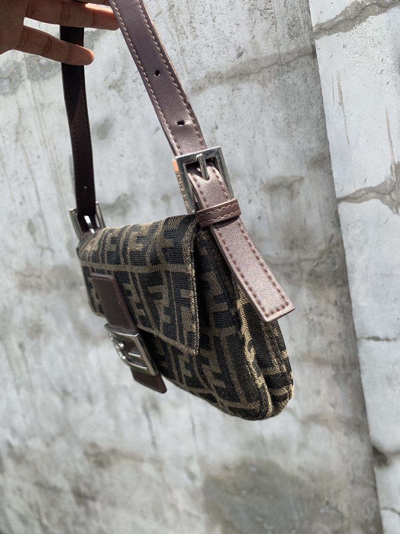 Fendi Zucca Baguette Bag (Category: Luxury Bags & Wallets) located in Polomolok. Submitted by domingthriftclothes (Listing ID 1443981863, Image 2). Description: - Classic Fendi Zucca baguette bag - Monogram canvas with leather trim - Silver hardware - Zipper closure inside - Made in Italy - Timeless piece, great for everyday use.