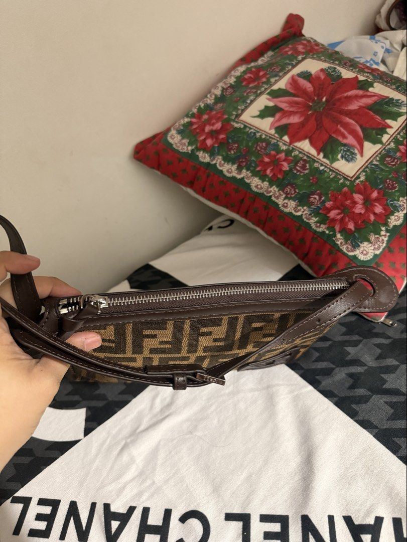 Fendi Zucca Canvas Baguette Bag (Category: Luxury Bags & Wallets) located in Del Monte. Submitted by shiminmishi (Listing ID 1441193747, Image 3). Description: - Fendi Zucca canvas baguette bag - Classic brown and black monogram print - Genuine leather trim and strap - Secure zipper closure - Compact size, perfect for essentials - Please note: Shows some signs of wear on the leather trim and strap NGA! with etiketa and code. no issue or flaws pre