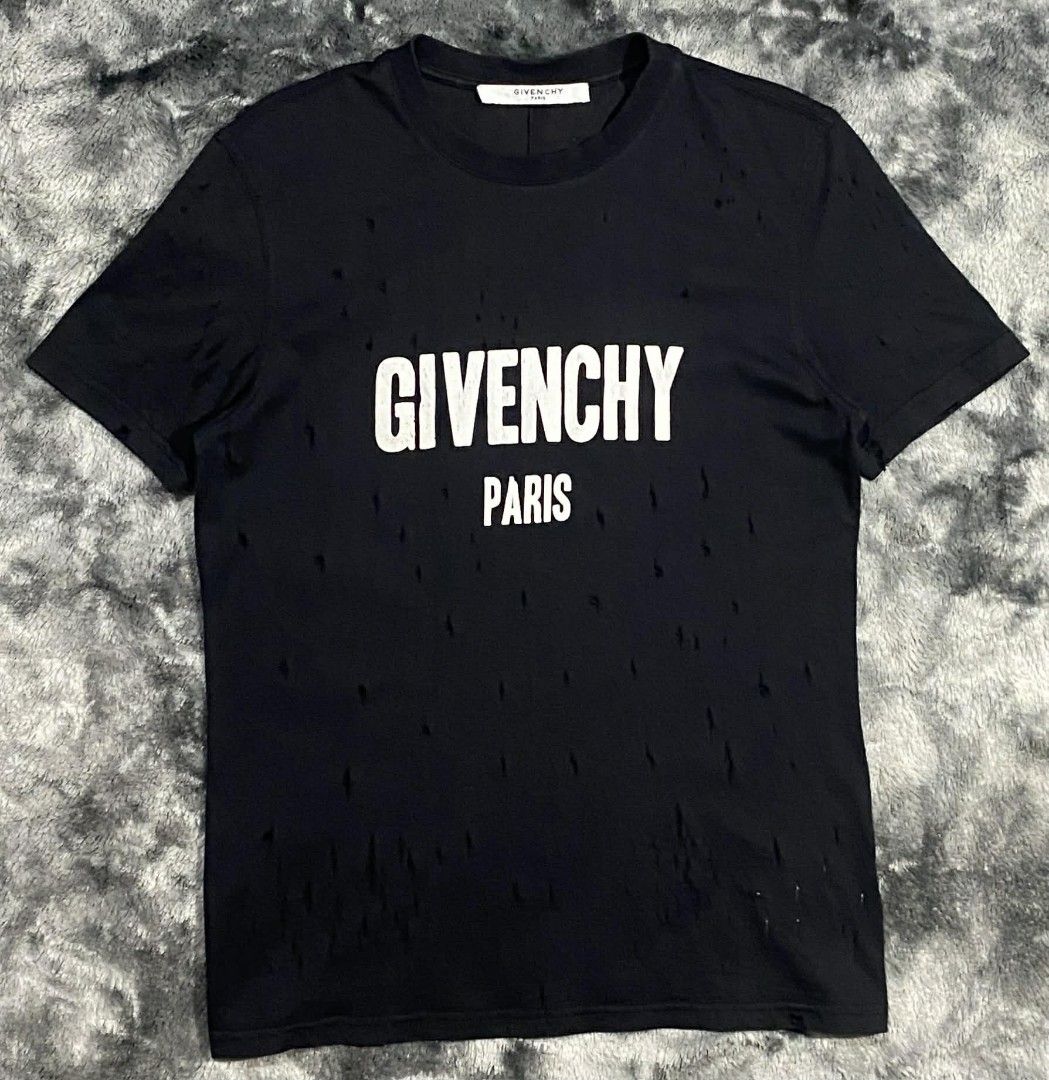 Givenchy Paris Distressed Black T-Shirt Size M (Category: Tshirts & Polo Shirts ) located in Sorsogon. Submitted by johnmichae69459 (Listing ID 1444020504, Image 1). Description: - Black Givenchy Paris T-shirt - Size: M - 19 width - 27 lenght - Distressed detailing throughout - Crew neck, short sleeves - Material: 100% Cotton with elastane for stretch - Refer to label for care instructions.