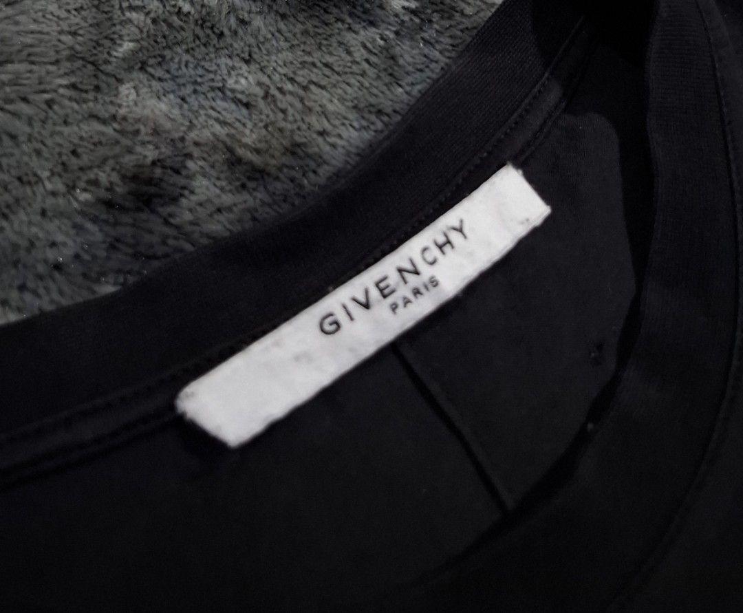 Givenchy Paris Distressed Black T-Shirt Size M (Category: Tshirts & Polo Shirts ) located in Sorsogon. Submitted by johnmichae69459 (Listing ID 1444020504, Image 3). Description: - Black Givenchy Paris T-shirt - Size: M - 19 width - 27 lenght - Distressed detailing throughout - Crew neck, short sleeves - Material: 100% Cotton with elastane for stretch - Refer to label for care instructions.