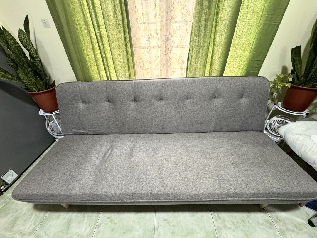 Grey Sofa Bed and Green Armchair Set (Category: Sofas) located in Lucena. Submitted by angelicadon (Listing ID 1443978356, Image 1). Description: - Grey sofa bed with pull-out function, perfect for guests. - Comfortable and spacious green armchair. - Both pieces are fabric upholstered. - Selling as a set. - Pick up only..
