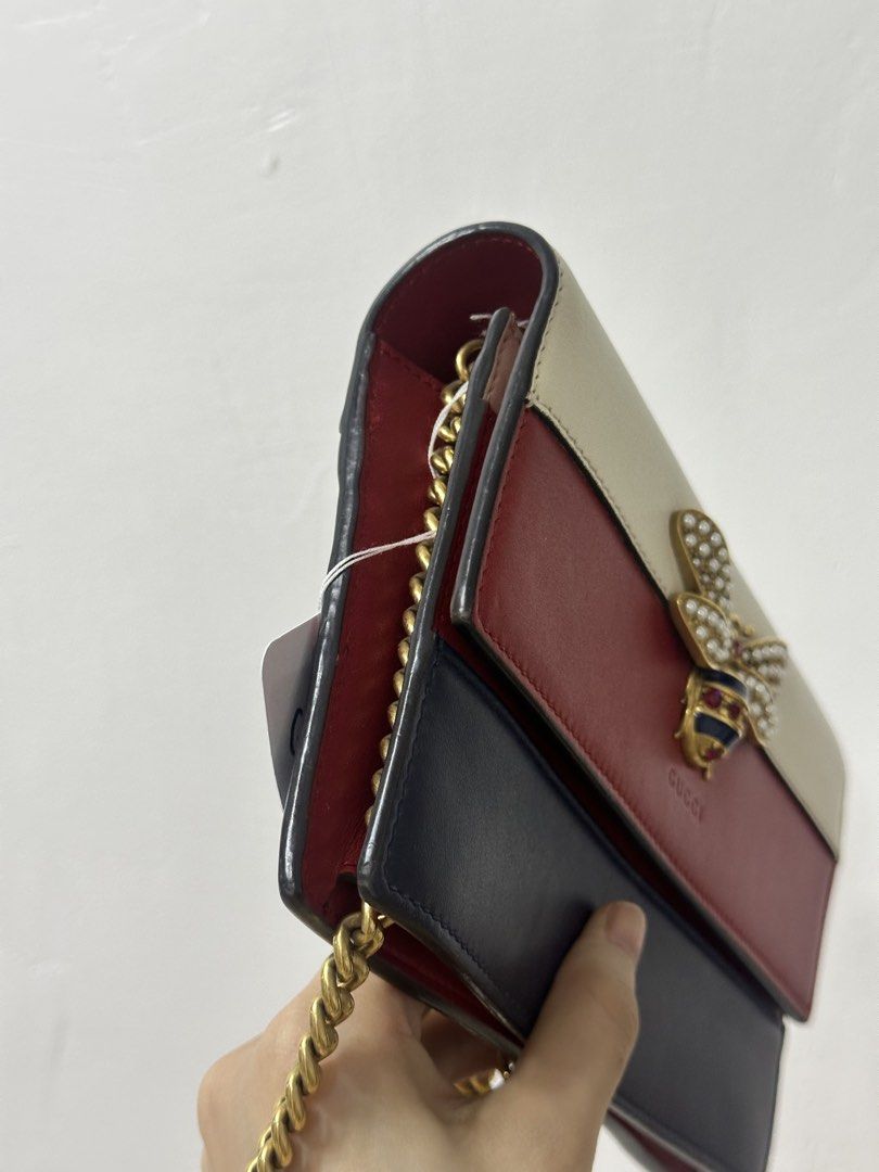 Gucci Bee Wallet on Chain Bag Tricolor (Category: Luxury Bags & Wallets) located in Cavite. Submitted by aljennaaaa (Listing ID 1444096610, Image 3). Description: - Authentic Gucci Wallet on Chain Bag - Iconic bee embellishment with pearl and crystal details - Stylish tricolor design: cream, red, and navy - Elegant gold chain strap - Interior features card slots and a zip pocket - Ideal for evening use or light travel.
