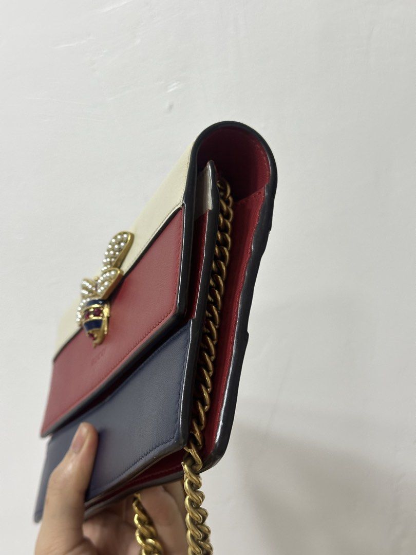 Gucci Bee Wallet on Chain Bag Tricolor (Category: Luxury Bags & Wallets) located in Cavite. Submitted by aljennaaaa (Listing ID 1444096610, Image 2). Description: - Authentic Gucci Wallet on Chain Bag - Iconic bee embellishment with pearl and crystal details - Stylish tricolor design: cream, red, and navy - Elegant gold chain strap - Interior features card slots and a zip pocket - Ideal for evening use or light travel.