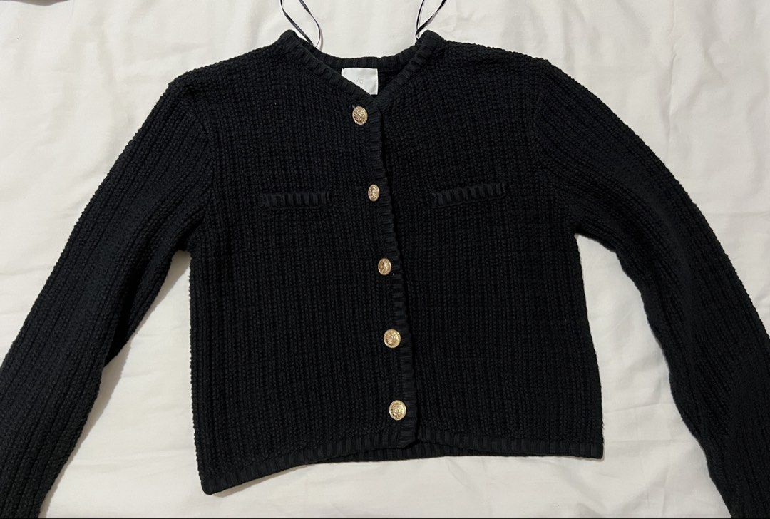 H&M Black Knit Cropped Cardigan (Category: Coats, Jackets and Outerwear) located in Pasig City. Submitted by shop.rdm (Listing ID 1444087440, Image 1). Description: - Black knit cardigan from H&M - Features elegant gold buttons down the front - Ribbed texture for a classic look - Long sleeves for comfortable layering - Versatile style: dress up or down.