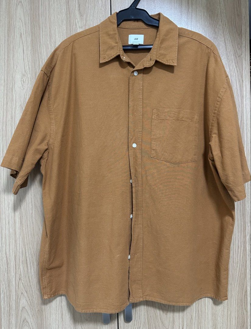 H&M Short Sleeve Button Up Shirt (Category: Tshirts & Polo Shirts ) located in Manila. Submitted by gpreloved2026 (Listing ID 1444006935, Image 1). Description: - Brand: H&M - Color: Brown - Sleeves: Short sleeve - Style: Button-up shirt Shipping c/o buyer No return, no exchange .
