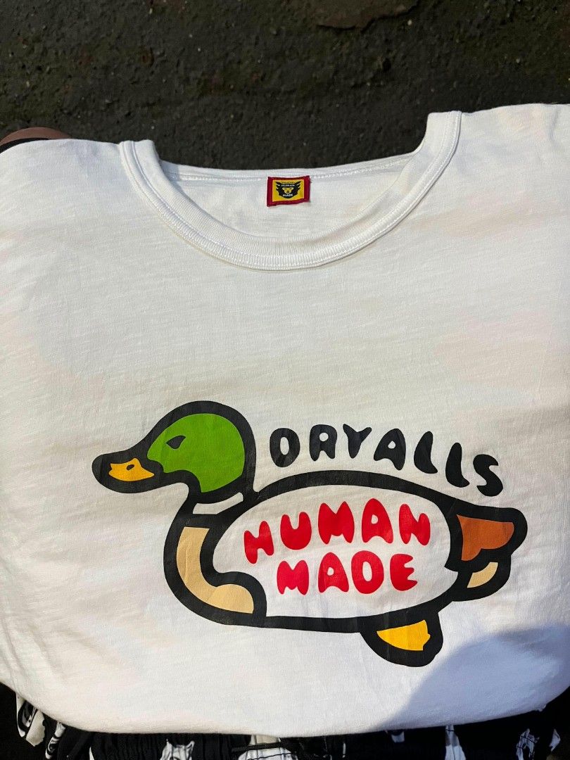 Human Made Duck Graphic T-Shirt White Medium (Category: Tshirts & Polo Shirts ) located in Manila. Submitted by harveyyay07523 (Listing ID 1444048698, Image 1). Description: - White Human Made T-shirt - Tagged Medium - Features classic duck graphic on front - Human Made heart logo on back - Made in Japan - Essential for any streetwear collection - Please check photos for condition details.