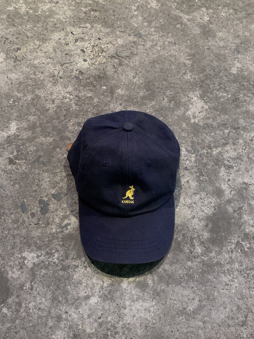 Kangol Navy Blue Baseball Cap with Leather Strap (Category: Caps & Hats) located in Manila. Submitted by loyspalencia (Listing ID 1444037014, Image 1). Description: - Navy blue Kangol baseball cap - Features classic yellow embroidered kangaroo logo on the front - Adjustable leather strap at the back for a custom fit - Ideal for everyday casual wear.