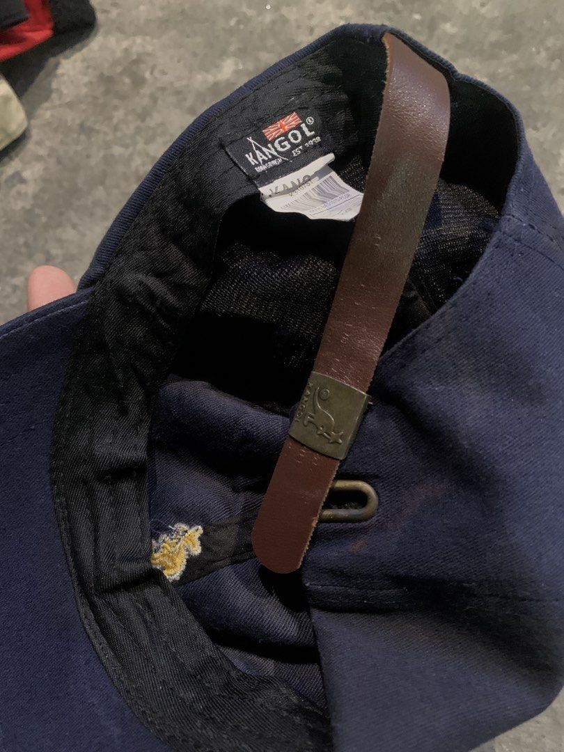 Kangol Navy Blue Baseball Cap with Leather Strap (Category: Caps & Hats) located in Manila. Submitted by loyspalencia (Listing ID 1444037014, Image 2). Description: - Navy blue Kangol baseball cap - Features classic yellow embroidered kangaroo logo on the front - Adjustable leather strap at the back for a custom fit - Ideal for everyday casual wear.