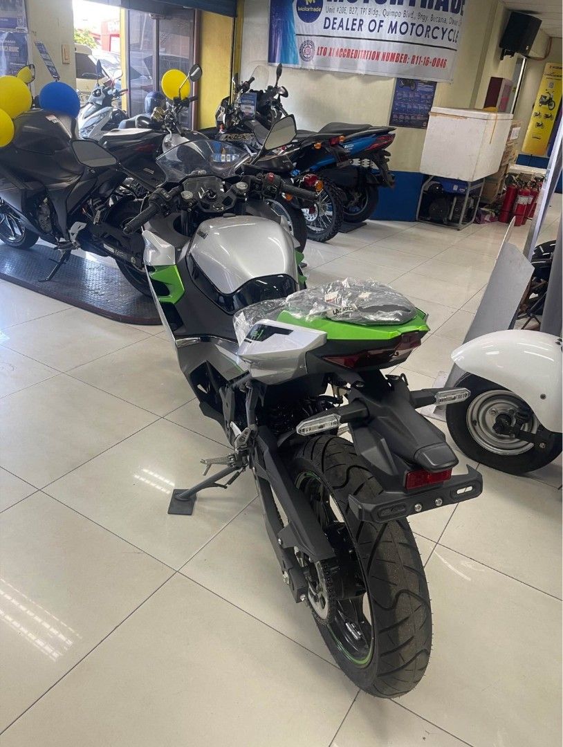 Kawasaki Ninja EV Electric Motorcycle (Category: Motorbikes for Sale) located in Davao. Submitted by dareyl_121422 (Listing ID 1443955640, Image 3). Description: Silver and green electric Ninja motorcycle. Looks sharp and sporty. Ready for a new rider. Great for city commuting or weekend rides. Low maintenance electric power. Get around town in style. Message for details..
