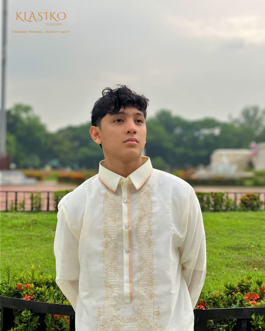 Klasiko Threads Pinya Jusilyn (Category: Formal Shirts) located in Quezon City. Submitted by klasikothreads2025 (Listing ID 1443956907, Image 3). Description: - Cream-colored Barong Tagalog made from high quality Pinya Jusilyn fabric - Intricate gold embroidery on the front - Classic collar with subtle peach trim - Long sleeves with button cuffs - Ideal for formal events and cultural celebrations - Timeless design with a modern feel.