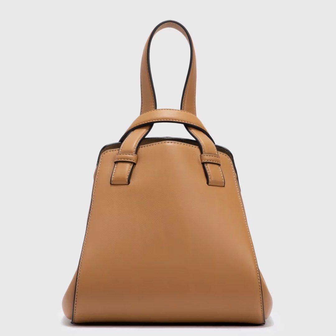 Loewe Hammock Nugget in Tan Leather (Category: Luxury Bags & Wallets) located in Makati City. Submitted by the_ambitious_peasant (Listing ID 1443947367, Image 3). Description: - Loewe Hammock Nugget in Tan Leather - Color: Tan - Material: Soft leather - Carrying options: Handheld or crossbody - Interior: Suede lined - Size: Ideal for essentials - bag and dust bag - Rank: 9/10 Note: there are very minimal signs of wear. Small white spots (not visi