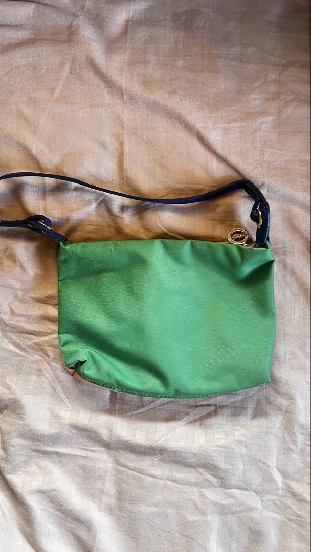Longchamp (Category: Cross-body Bags) located in Taguig. Submitted by declutter67 (Listing ID 1443967423, Image 2). Description: - Cute Longchamp shoulder bag - Reversible design: Green on one side, Pink on the other - Blue leather strap and trim - Gold zipper detail - Great for everyday use - Plenty of space inside for essentials.